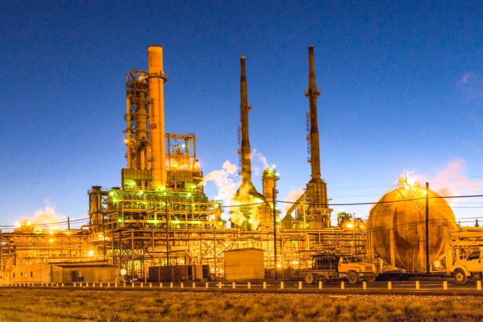 Oil refinery and process plant illuminated at dusk